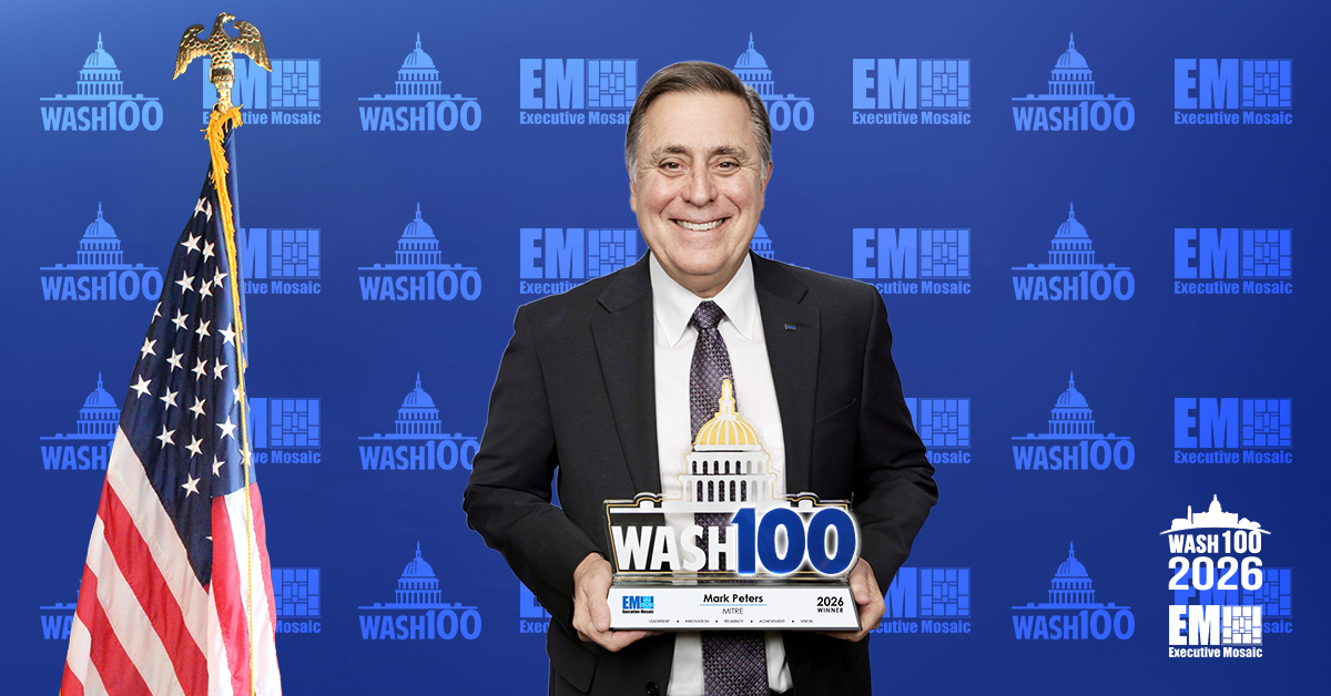 Mark Peters, president and CEO of MITRE, holding his 2026 Wash100 Award. Peters is a two-time Wash100 winner