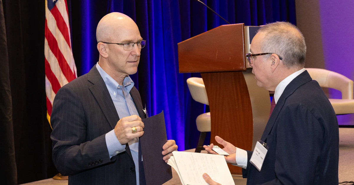 Barry Tanner and GovCon industry member. The acting Navy CIO networked with conference attendees at the 2025 Navy Summit.