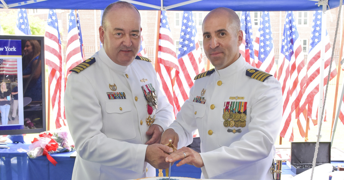 Jason Tama. The previously USCG captain (right) poses in 2018.
