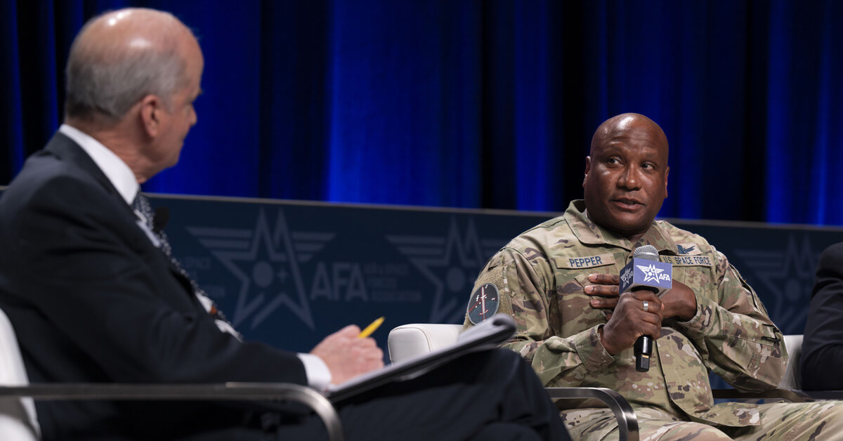 Photo of Maj. Gen Devin Pepper (right) speaking at the Air Force Association's Air Warfare Symposium in February 2024