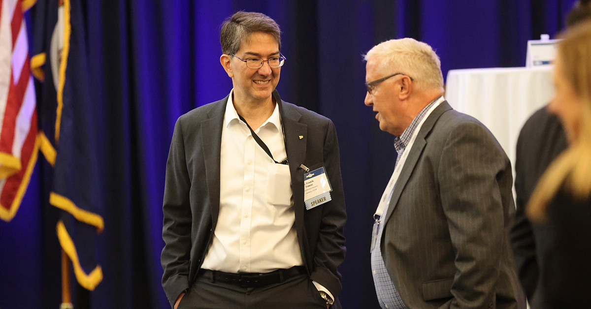 Fredrik Fatemi. The DEVCOM Army Research Laboratory official engages with a guest at the 2026 Cyber Summit.