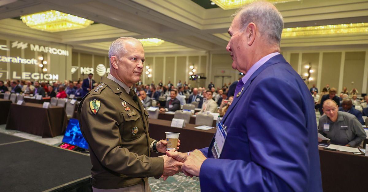 Lt. Gen. Robert Collins, principal acquisition, logistics and technology and director of the Army Acquisition Corps (left), engages with industry at the 2026 Army Summit. Photo: Executive Mosaic